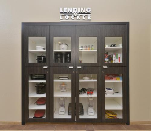 a display cabinet with glass doors in a room at Candlewood Suites Eugene Springfield by IHG in Eugene