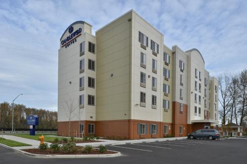 a building with a sign on the side of it at Candlewood Suites Eugene Springfield by IHG in Eugene