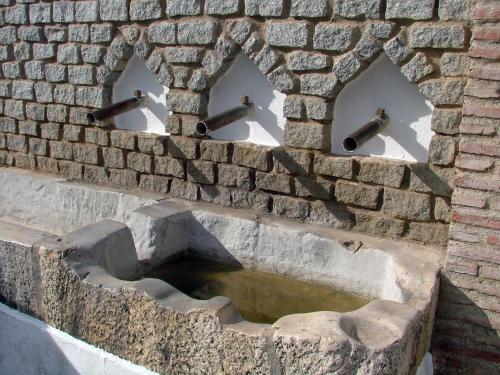 a brick wall with a water fountain in it at Casa El Olivo by CasaTuristica in Benalauría