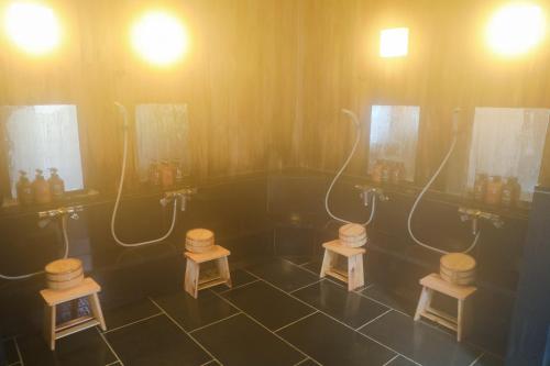 a bathroom with three sinks and two mirrors at Ajisai Onsen Ryokan in Hakone