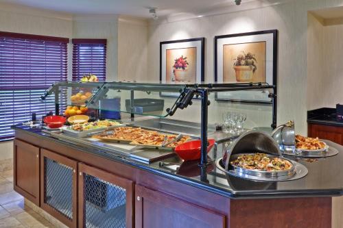 a buffet with many different types of pizzas on it at Staybridge Suites Buffalo by IHG in Buffalo