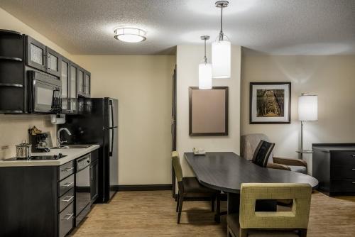 a kitchen and dining room with a table and chairs at Candlewood Suites Glen Allen-Short Pump in Glen Allen