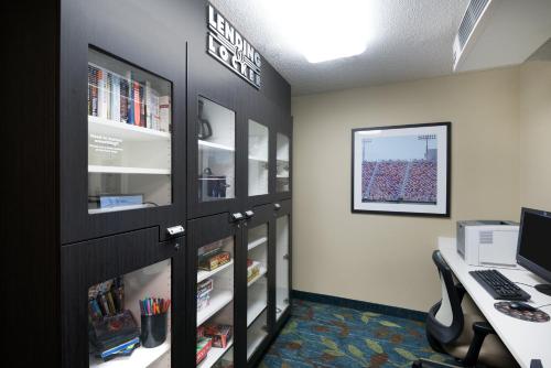 an office cubicle with a desk and a computer monitor at Candlewood Suites Glen Allen-Short Pump in Glen Allen