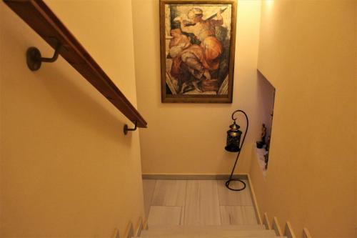 a hallway with a painting on the wall and a stairway at Sofotel in Koroni