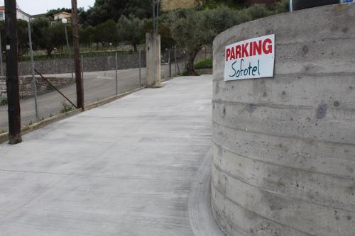 a sign on a wall with a parking sign on it at Sofotel in Koroni