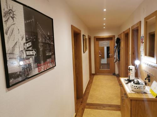 a hallway with a large picture hanging on the wall at Hotelpension Oberauer Wagrain in Wagrain