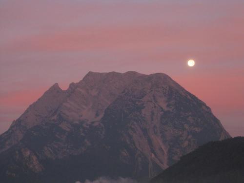 a mountain with the moon in the sky at Haus Moser in Wörschach
