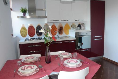 a kitchen with a table with plates on it at Una Casa al Belvedere in Enna