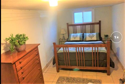 a bedroom with a bed and a dresser and a window at First Floor One Bedroom Apartment with Full Kitchen & Bath in Washington
