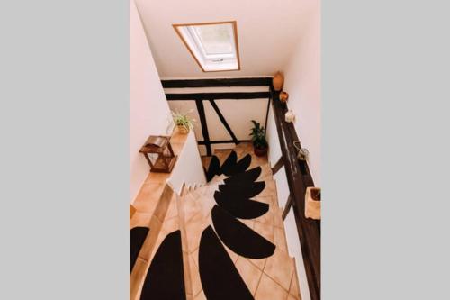 a room with a staircase with black and white at Ferienwohnung Casa del Vino in Erbach im Odenwald