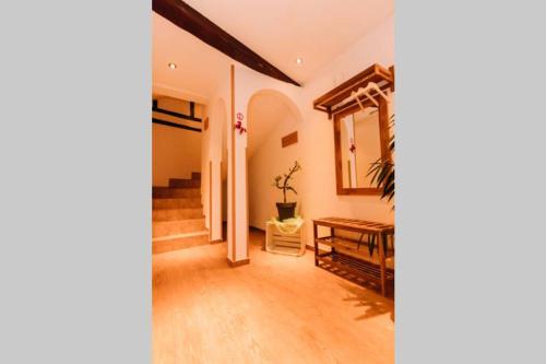 a living room with a table and a mirror at Ferienwohnung Casa del Vino in Erbach im Odenwald