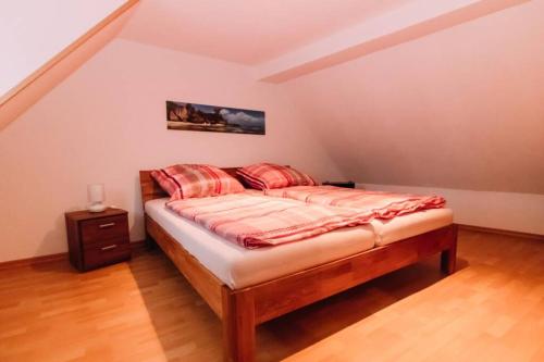 a bedroom with a bed with red pillows on it at Ferienwohnung Casa del Vino in Erbach im Odenwald