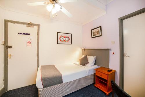 a hotel room with a bed and a ceiling fan at Marina in Sandown