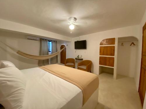 a bedroom with a white bed and a desk at MIO Cancún Hotel Boutique in Cancún