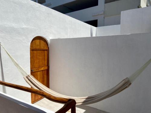 a hammock on the side of a building with a door at MIO Cancún Hotel Boutique in Cancún