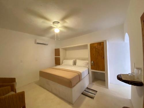 a bedroom with a bed and a chair in a room at MIO Cancún Hotel Boutique in Cancún