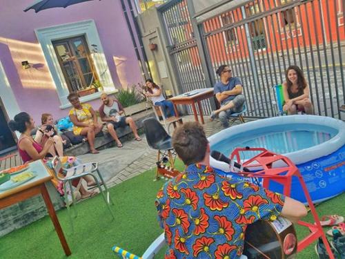 a group of people sitting around in a backyard at Hostel Matilda in Curitiba