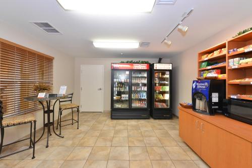 a store with two refrigerators and a table with chairs at Candlewood Suites Gillette by IHG in Gillette