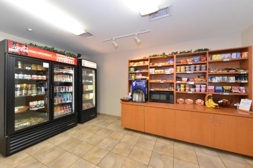 a grocery store with two refrigerators and a counter at Candlewood Suites Gillette by IHG in Gillette