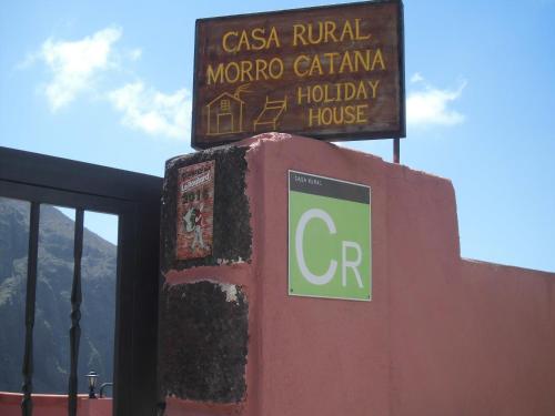 a sign on top of a building next to a building at Live Masca - Estudio casas morrocatana Tenerife in Masca