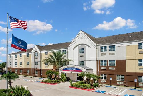 an image of a hotel with an american flag at Candlewood Suites Galveston by IHG in Galveston