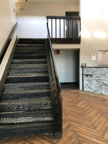 an empty staircase in a building with wooden floors at HomeTown Inn in Clearwater
