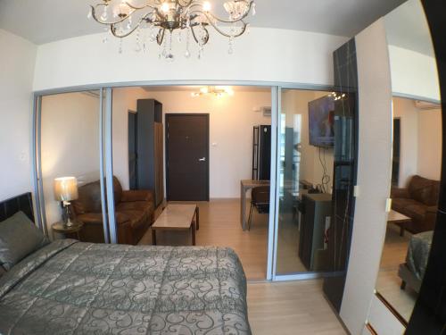 曼谷的住宿－Supalai Rama9 Monthly，一间卧室设有一张床和一间客厅。