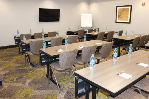 a room with tables and chairs with water bottles on them at Staybridge Suites Miamisburg by IHG in Miamisburg