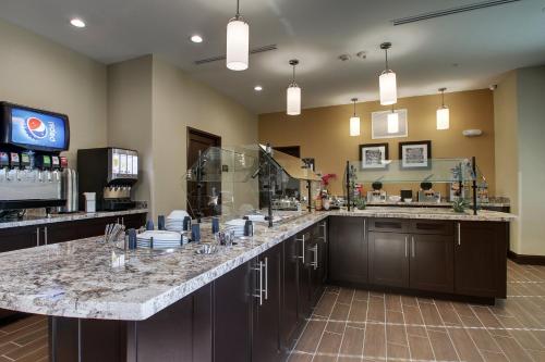a kitchen with a large counter with glasses on it at Staybridge Suites Plano - The Colony, an IHG Hotel in The Colony