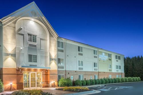 an exterior view of a hotel at night at Candlewood Suites Hopewell by IHG in Hopewell
