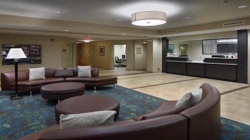 a hotel lobby with couches and a living room at Candlewood Suites - Newark South - University Area by IHG in Newark