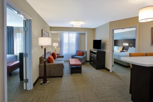 a hotel suite with a living room and a bedroom at Staybridge Suites - Benton Harbor-St. Joseph by IHG in Benton Harbor