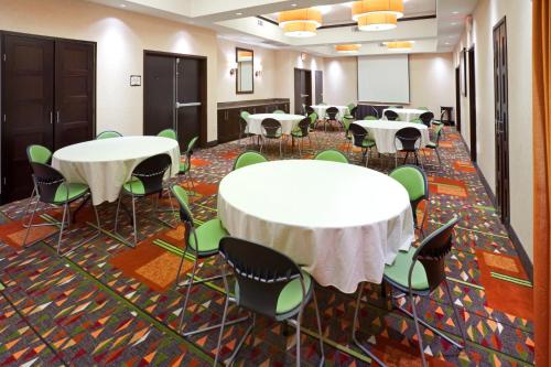 a conference room with tables and chairs and a podium at Staybridge Suites DFW Airport North by IHG in Irving