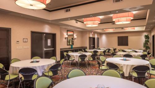 a conference room with tables and chairs at Staybridge Suites DFW Airport North by IHG in Irving