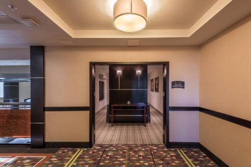 a hallway with a door leading to a room at Staybridge Suites DFW Airport North by IHG in Irving