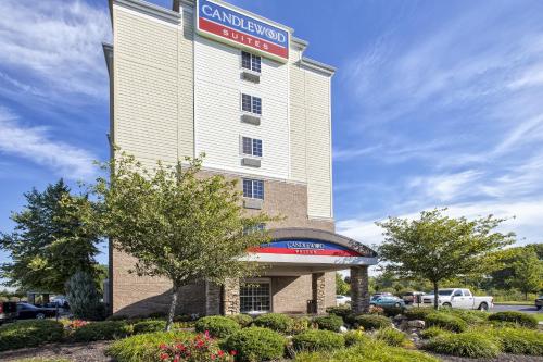 a building with a sign on the side of it at Candlewood Suites Indianapolis Airport by IHG in Indianapolis
