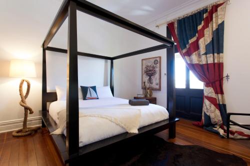 
a bed room with a bed with a canopy on top of it at SoBe Fremantle in Fremantle
