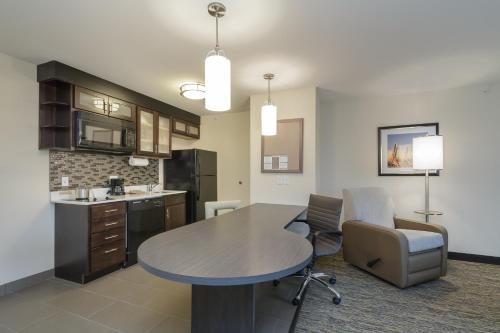 a kitchen and living room with a table and chairs at Candlewood Suites Mishawaka by IHG in Mishawaka