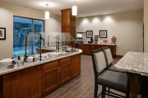 a kitchen with a large island with a fish tank at Staybridge Suites Des Moines Downtown by IHG in Des Moines