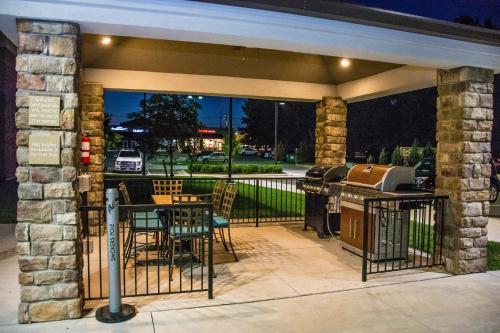a patio with a grill and a table and chairs at Candlewood Suites Overland Park W 135th St by IHG in Overland Park