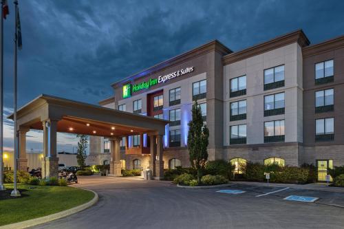 a hotel exterior at night with a gas station at Holiday Inn Express & Suites - Belleville by IHG in Belleville