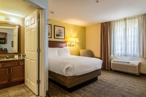 A bed or beds in a room at Candlewood Suites Jacksonville East Merril Road, an IHG Hotel