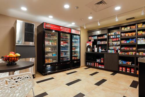a grocery store aisle with shelves of products at Candlewood Suites Lenexa - Overland Park Area by IHG in Lenexa