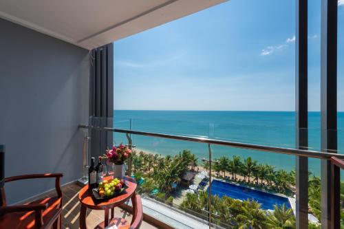 a balcony with a table and a view of the ocean at Amarin Resort & Spa Phu Quoc in Phu Quoc