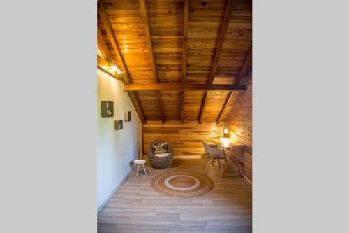 a room with a wooden ceiling and a table at Barbadine in La Plaine des Cafres
