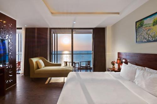a hotel room with a bed and a view of the ocean at Amarin Resort & Spa Phu Quoc in Phu Quoc