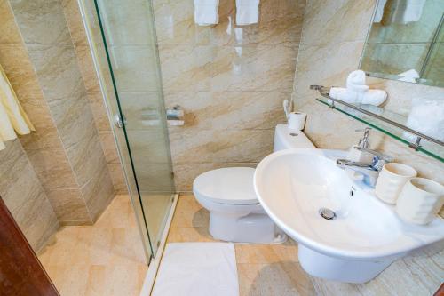 a bathroom with a toilet and a sink and a shower at WECOZY HANOI - Railway Side, The Old Quarter in Hanoi
