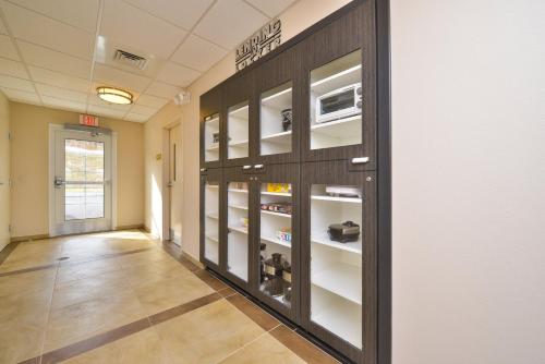 a hallway with glass doors and shelves in a room at Candlewood Suites Harrisburg-Hershey by IHG in Harrisburg