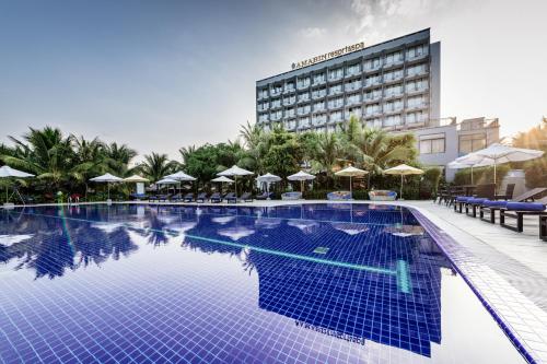 a large swimming pool with umbrellas and a hotel at Amarin Resort & Spa Phu Quoc in Phu Quoc