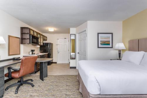 a hotel room with a bed and a desk at Candlewood Suites Secaucus by IHG in Secaucus